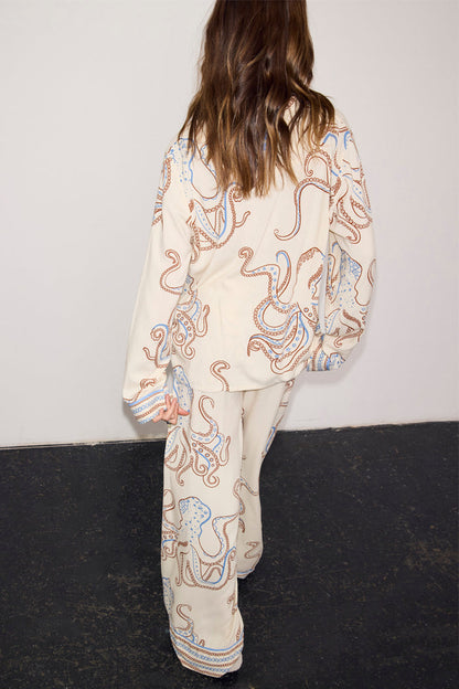Cream Button Through Pyjamas with a blue and brown octopus print, shown from the back on a model.