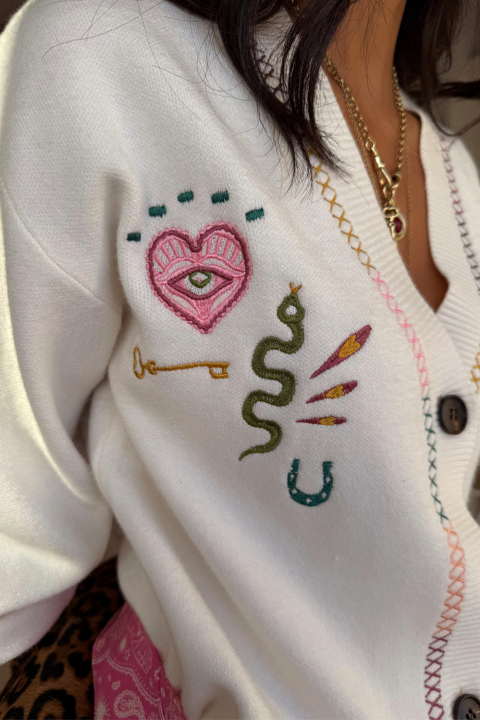 Cream Western Martha Cardigan detail with embroidered motifs and multi-coloured criss-cross stitching.