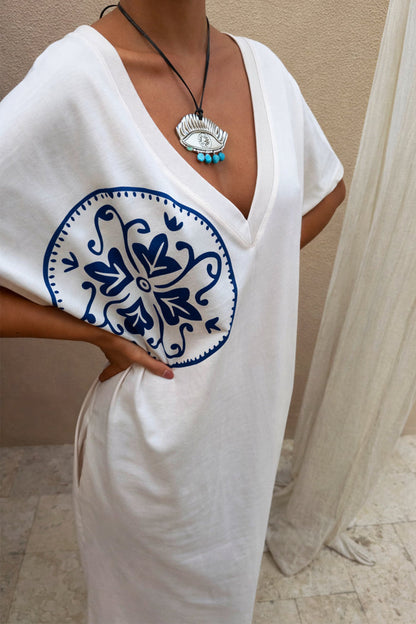 Iconic Deloris Eye Necklace with a vintage-style metal pendant, blue stone drops, and adjustable leather cord.