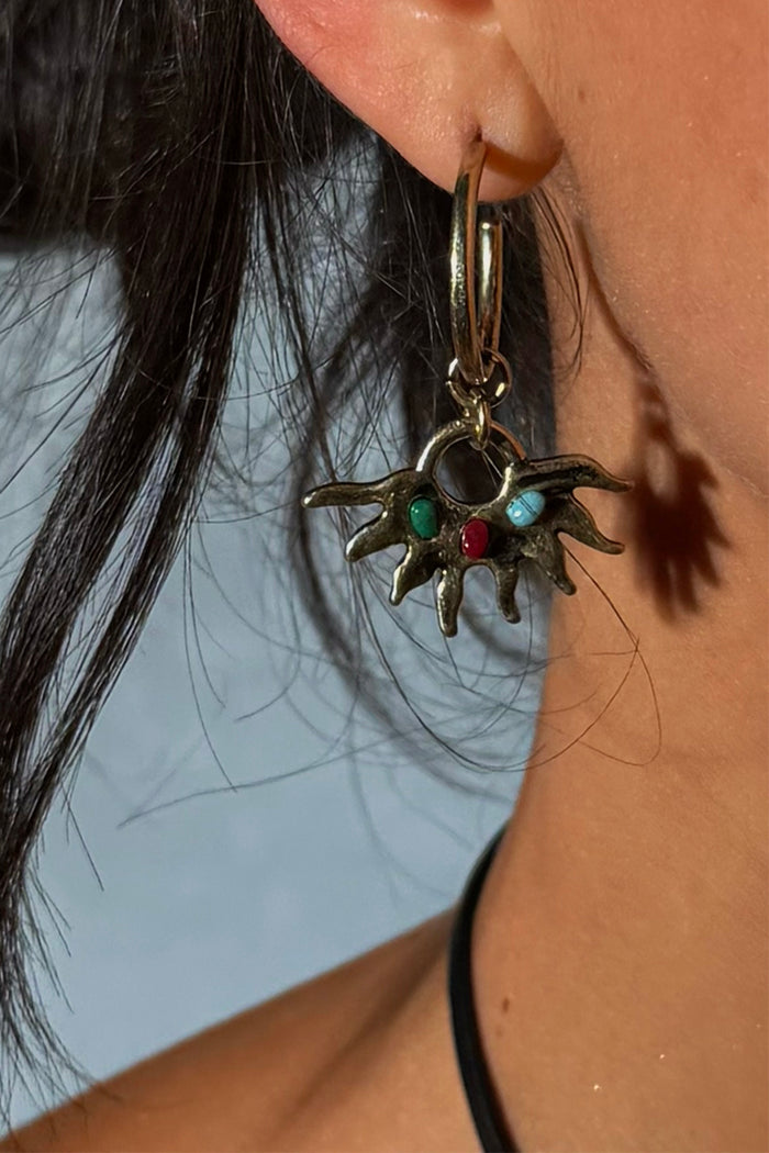 Gold-tone Deloris Sun Hoop Earring featuring a sun motif with colourful semi-precious stones, worn on the ear.