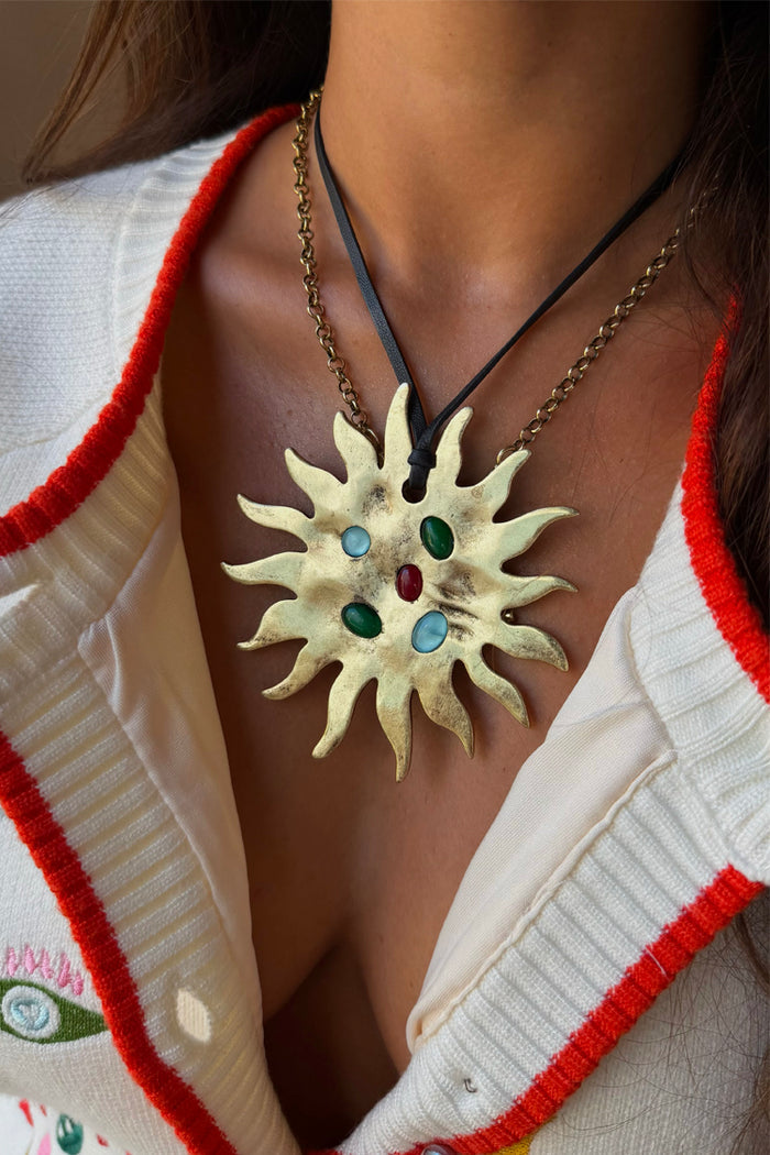 Deloris Sun Necklace in textured brass with colourful semi-precious stones and a black leather cord.