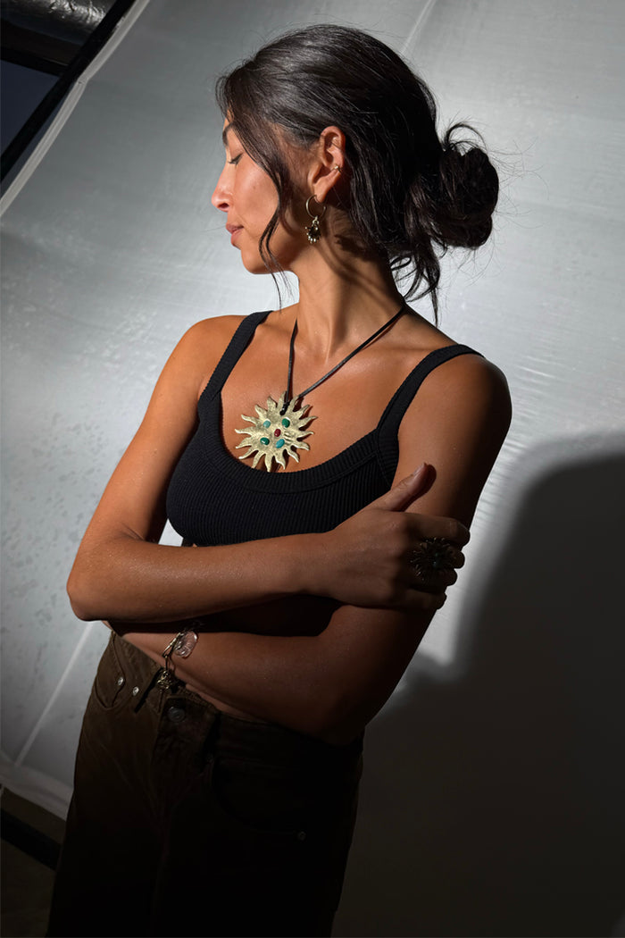Deloris Sun Necklace features a brass sun pendant with colourful semi-precious stones and a black leather cord.
