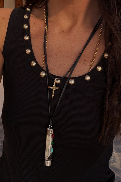 Deloris Whistle Necklace with a polished silver-tone pendant and colourful gemstones on a layered black leather cord.