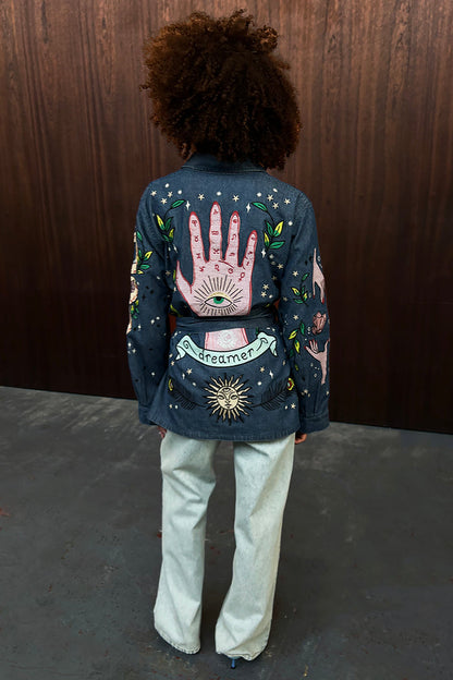 Denim Manifestation Jacket with intricate tarot-inspired embroidery and dreamer banner on the back.