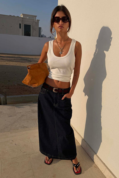 Dark blue Denim Pencil Skirt styled with a white ribbed vest and tan belt for a casual summertime look.