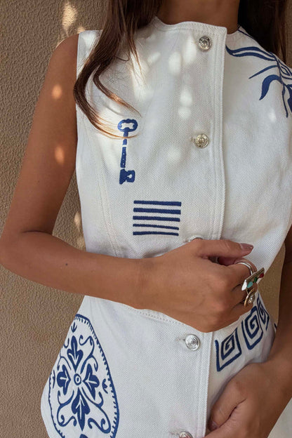 Ecru denim Dolce Vita Waistcoat featuring blue Greek-inspired embroidery, sun motifs and silver engraved buttons.