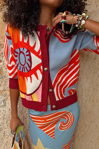 Dolce Vita Hollie Cardigan featuring an oversized eye print, swirling motifs and burgundy ribbed trims.
