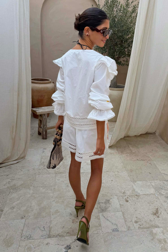 White Dreamer Ellie Shorts with cut-out hem and sun motifs, styled as a cotton co-ord for a summer vacation look.