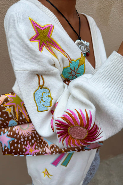 Dreamer Martha Cardigan in cream soft-touch knit with colourful embroidered sun and star motifs and a ribbed cuff.
