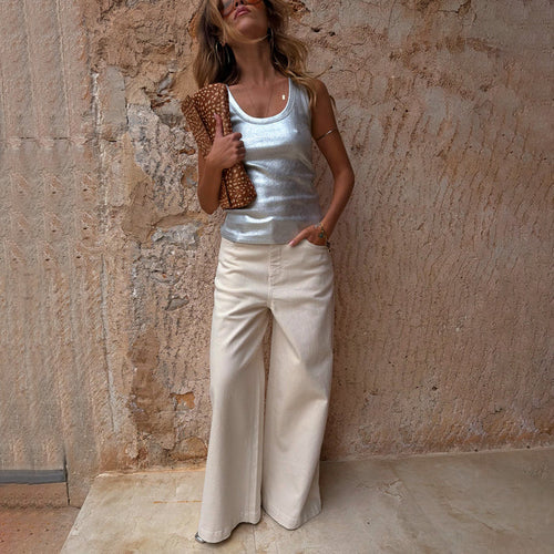 Ecru Jan Jeans with a wide palazzo leg, paired with a silver metallic tank top and leopard print clutch.