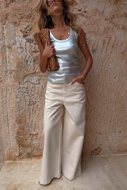 Ecru Jan Jeans with a wide palazzo leg, styled with a silver metallic top and leopard print clutch bag.