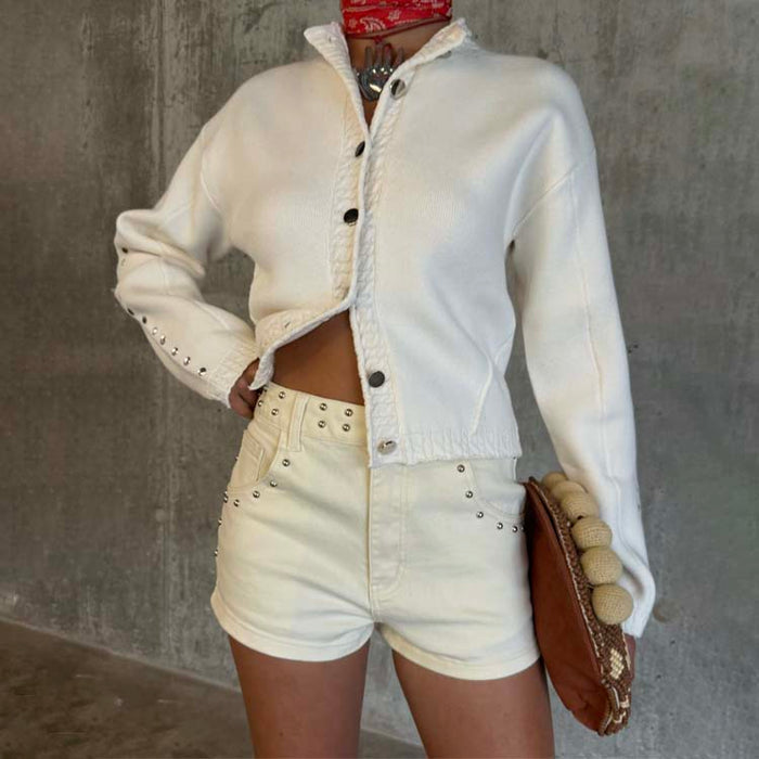 Ecru Studded Hot Pant with silver stud detailing, styled with a matching cream knit cardigan and a textured brown clutch.