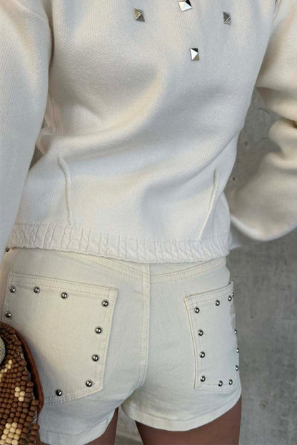 Ecru Studded Hot Pant with silver details on back pockets, paired with a matching cream top.