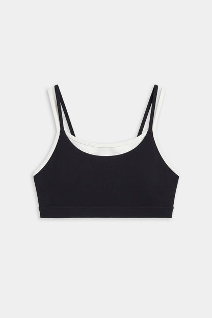 The SPLITS59 Elliah Airweight Double Layer Bra in black/white features double shoulder straps, white trim, and a soft spandex-nylon blend, shown on a plain white background.