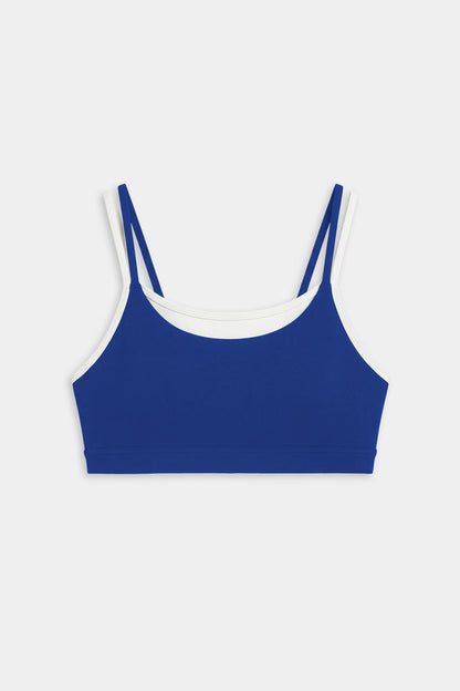 The SPLITS59 Elliah Airweight Double Layer Bra in cobalt with white trim features double shoulder straps and pairs perfectly with your favorite nylon spandex activewear. Displayed on a plain white background.