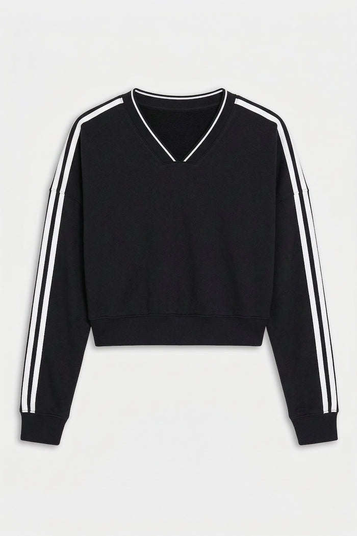 The SPLITS59 Ellie Fleece V Neck Sweatshirt in Black/White features long sleeves with white stripes, a cropped cut, and soft modal-spandex fabric, shown on a white background.