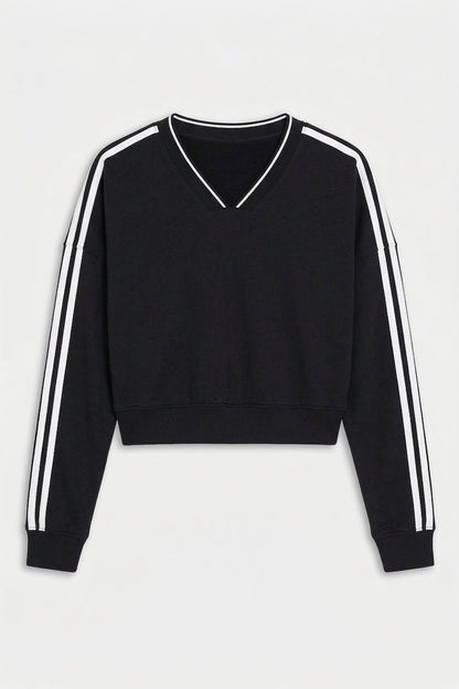 The SPLITS59 Ellie Fleece V Neck Sweatshirt in Black/White features long sleeves with white stripes, a cropped cut, and soft modal-spandex fabric, shown on a white background.