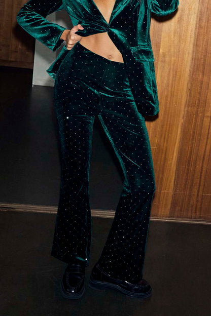 Emerald Velvet Trousers with diamond studs, styled with a matching blazer and black loafers.