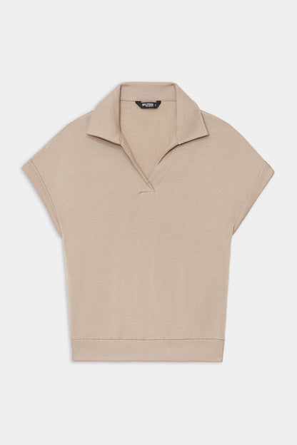The SPLITS59 Evie Fleece Sleeveless Polo in Latte features a soft fleece fabric, sleeveless design, classic collar, and V-neckline, shown against a white background.