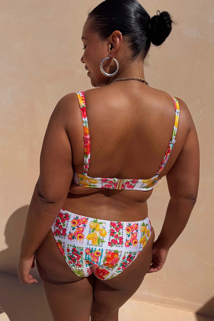 Fruit Stamps Bikini Bottoms and matching top in a cream citrus print, showcasing inclusive sizing from the back.