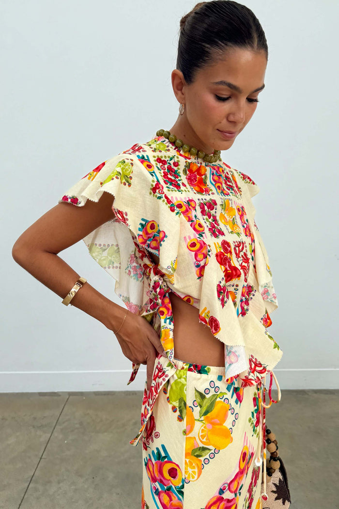 Cream Fruit Stamps Florence Top with layered ruffles, side ties and a Mediterranean fruit print.