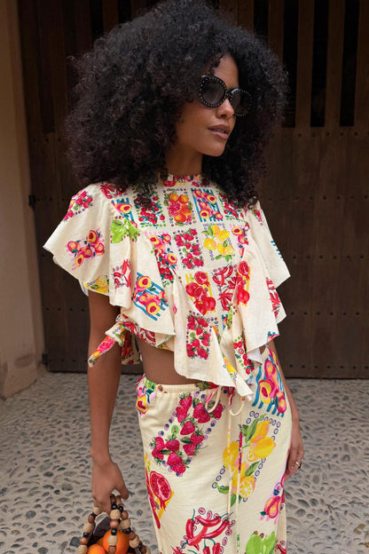 Fruit Stamps Florence Top in cream cotton-linen with Mediterranean fruit prints, asymmetric ruffles and side ties.