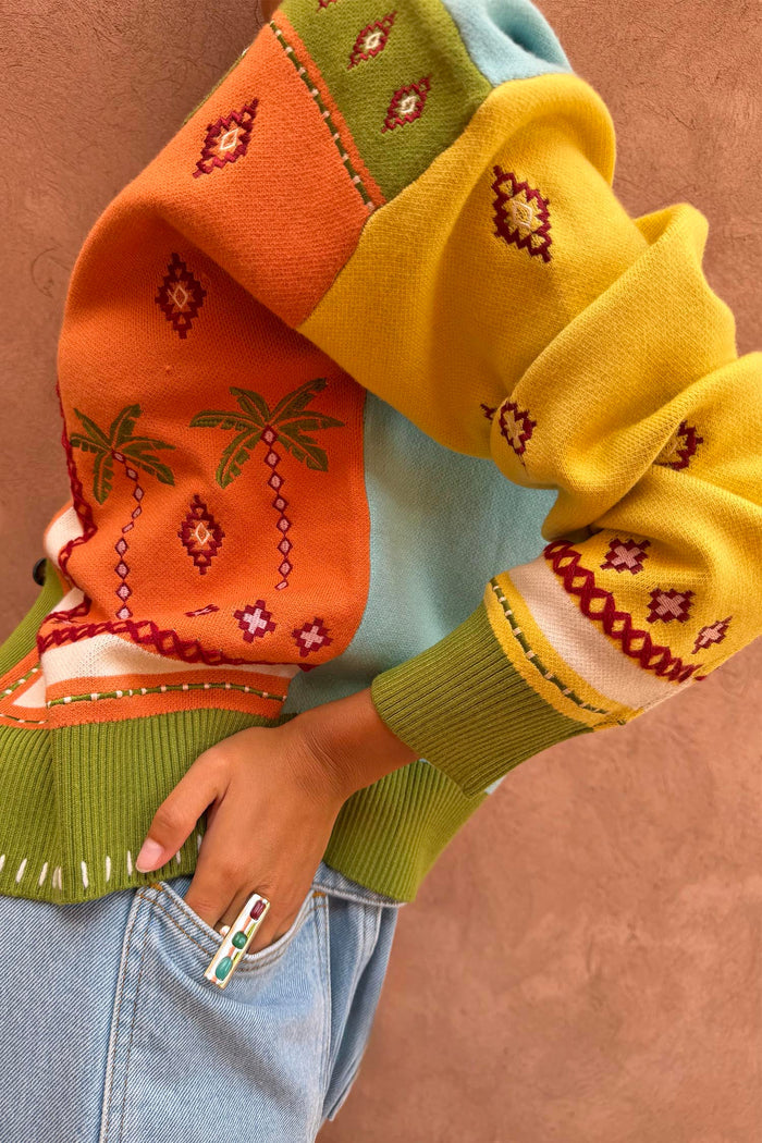 Geometric Palm Cardigan in a multi-colour knit featuring palm motifs, jacquard patterns and blanket stitch details.