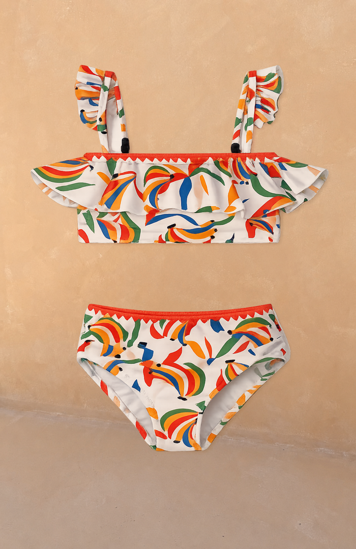 Cream Girl's Banana Bikini with a multicoloured fruit print, frilled bandeau top and pull-on bottoms.