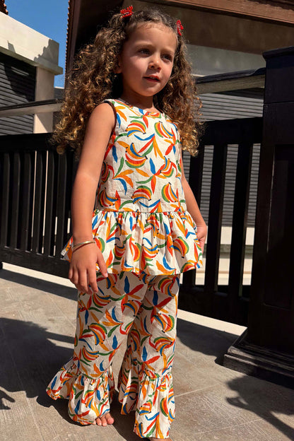 NFD Kids multicoloured banana print cotton co-ord with a sleeveless peplum top and flared trousers.