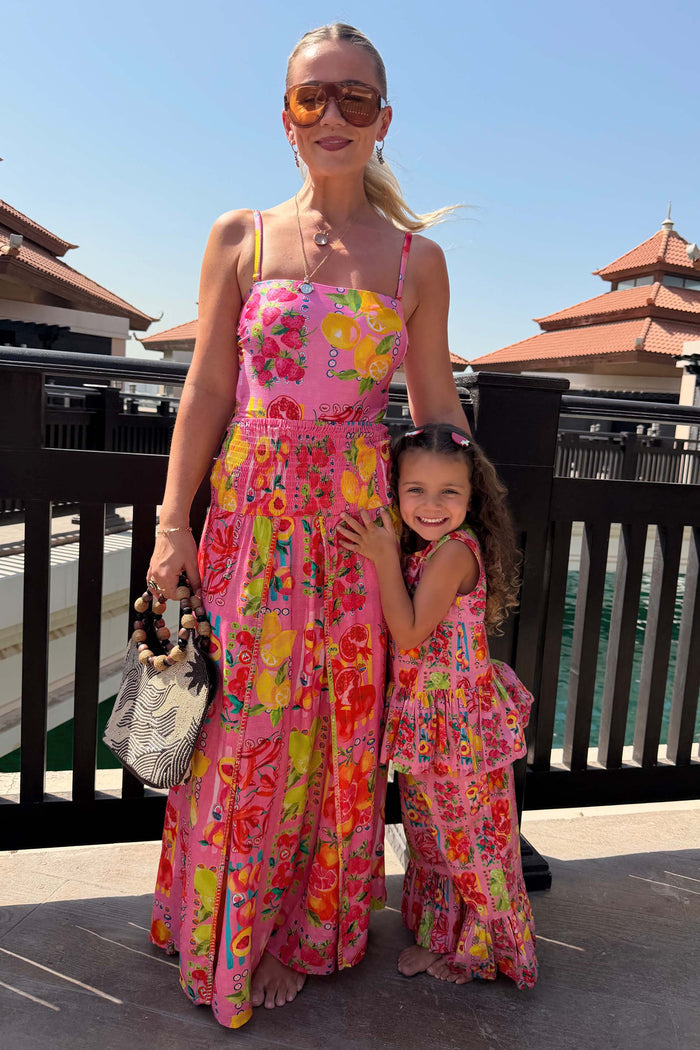 NFD Kids Pink Fruit Wide Leg Set with a peplum top and frill-hem trousers, shown on a girl for a vacation look.