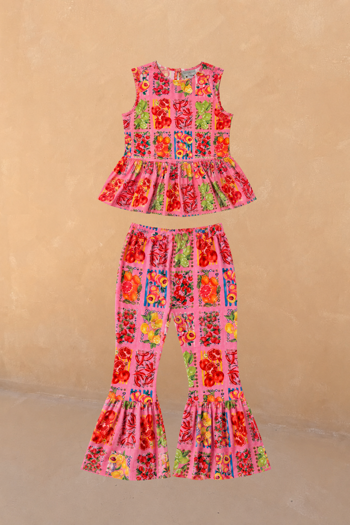 NFD Kids Pink Fruit Set in cotton with a sleeveless peplum top and matching wide leg frill hem trousers.