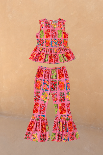 NFD Kids Pink Fruit Set in cotton with a sleeveless peplum top and matching wide leg frill hem trousers.