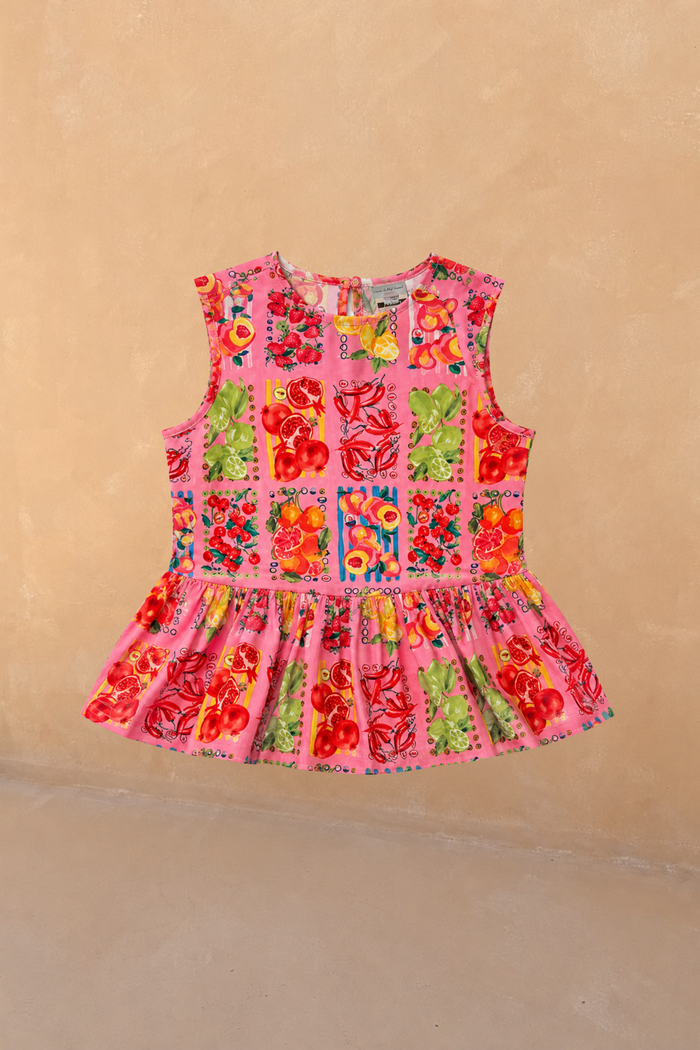 NFD Kids pink sleeveless peplum top with a Mediterranean-inspired fruit print in 100% cotton.
