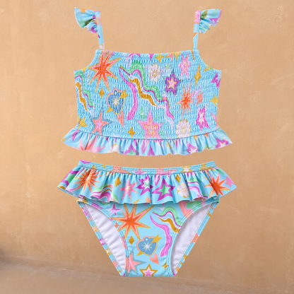 Blue Girl's Starburst Crop Bikini Set featuring a smocked top with frill straps and matching ruffle-trim bottoms.