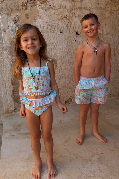 Blue Starburst crop bikini set with smocked frill details, paired with matching boys' swim shorts.