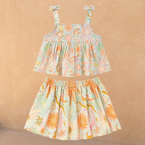 Girl's blue Starburst cotton co-ord with a sun and star print, peplum tie-strap top and tiered skirt.