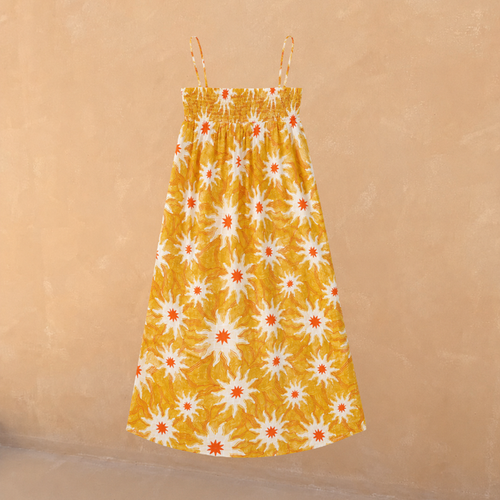 Girl's yellow cotton maxi sun dress with an orange sun print, shirred bodice and thin straps.