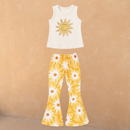 Cream cotton vest with a sequin sun and matching flared trousers in a yellow soleil print.