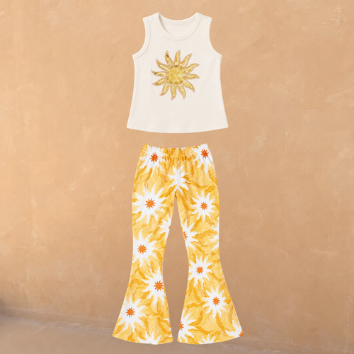 Cream cotton vest with a sequin sun and matching flared trousers in a yellow soleil print.