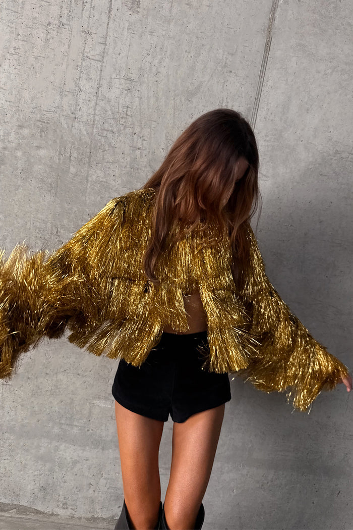 Metallic Gold Fringe Jacket featuring layered foil tassels and a cropped fit, styled for partywear.