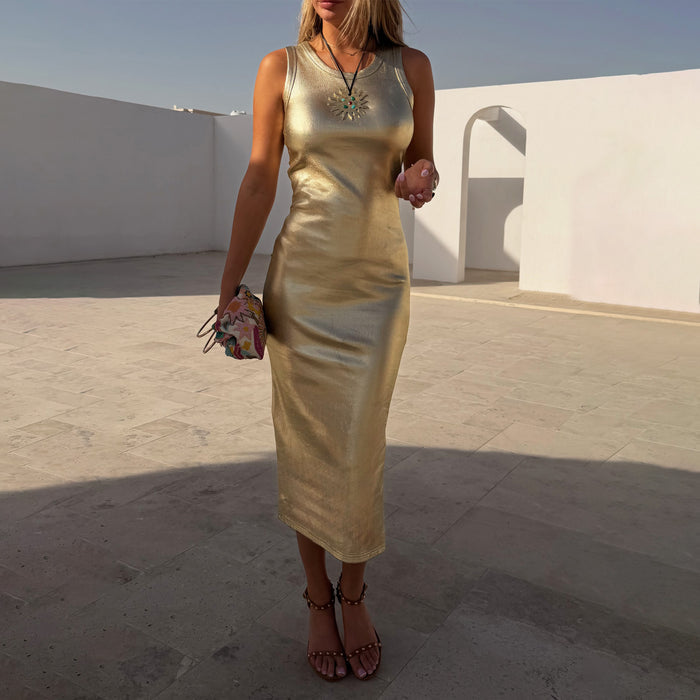 Sleeveless Gold Metallic Ribbed Dress with a shimmering finish and midi length, worn in a sunny white courtyard.