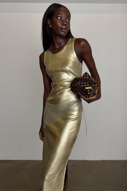 Gold Metallic Ribbed Dress with a sleeveless midi silhouette and side slit, styled with a silver chain belt.