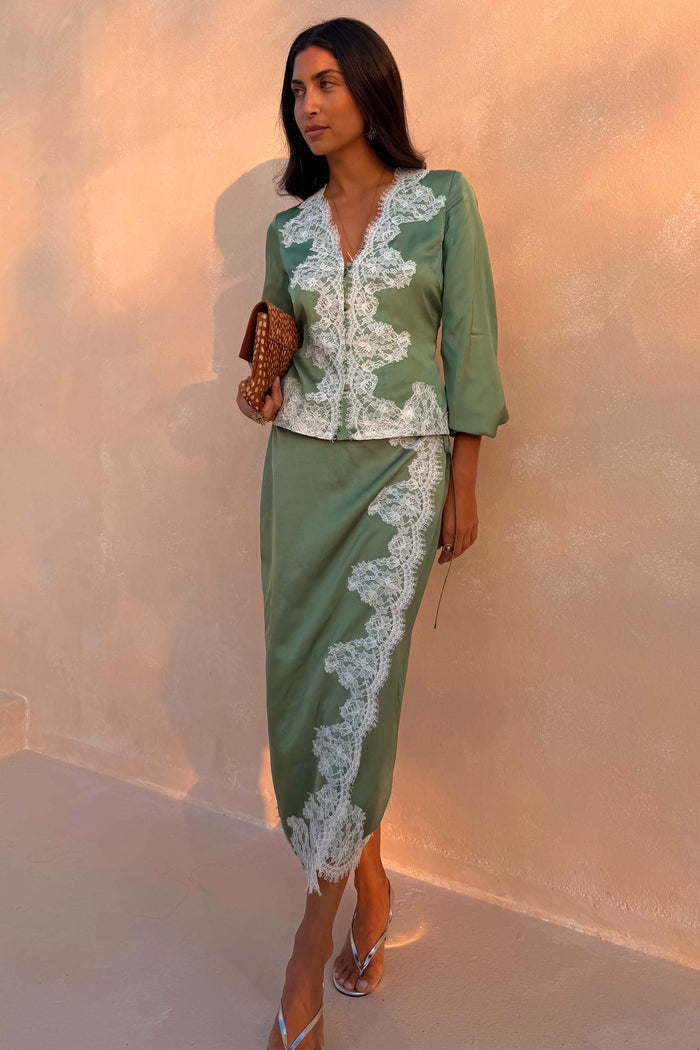 Green Lace Wrap Midi Skirt with cascading white lace and tie waist, styled with a matching top on a model.