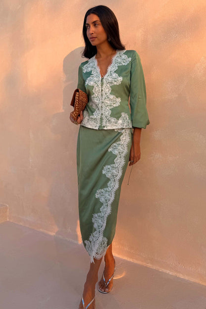 Green Lace Wrap Midi Skirt with cascading white lace and tie waist, styled with a matching top on a model.