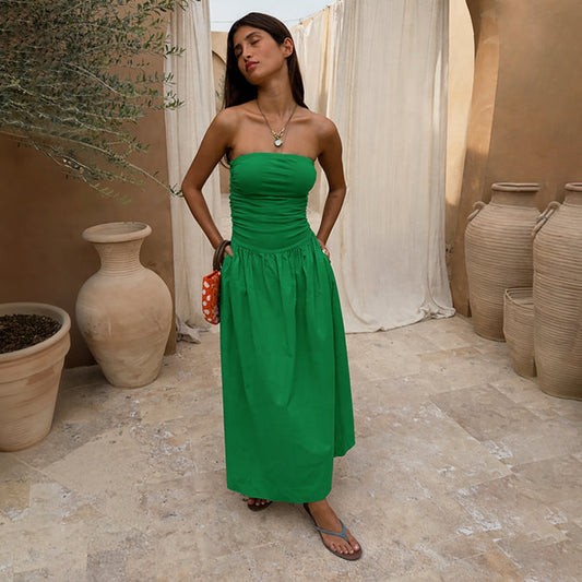 Green Lola Mid-axi Dress with a ruched strapless bodice and flowy cotton skirt, ideal for vacation dressing.