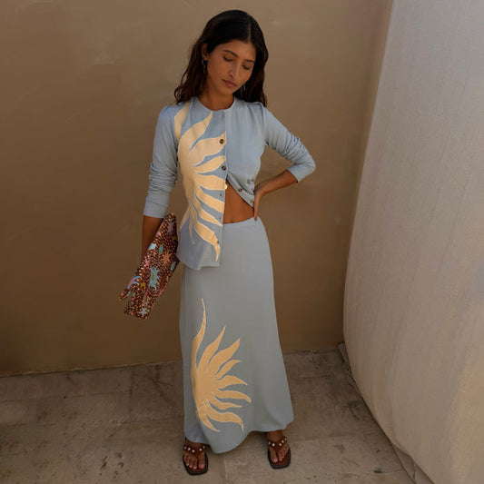 Ice blue Sol Dorris midi skirt featuring a hand-painted sun print on stretch rib fabric, styled as a co-ord.