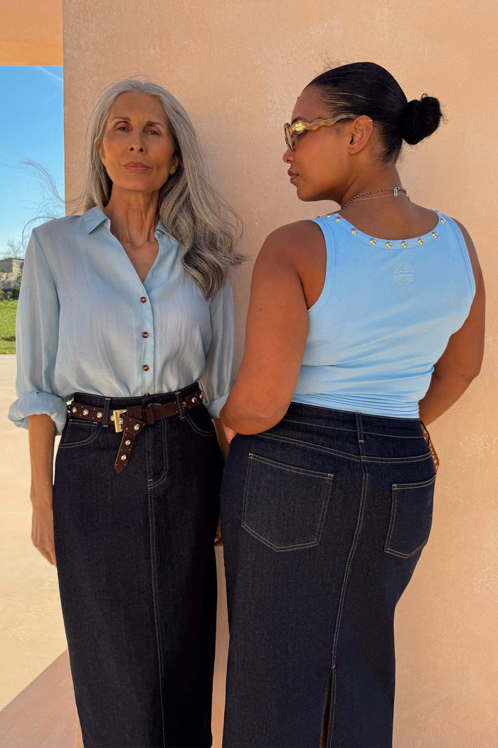 Ice Blue Studded Rib Vest with gold neckline studs, shown on two diverse models in dark denim skirts.