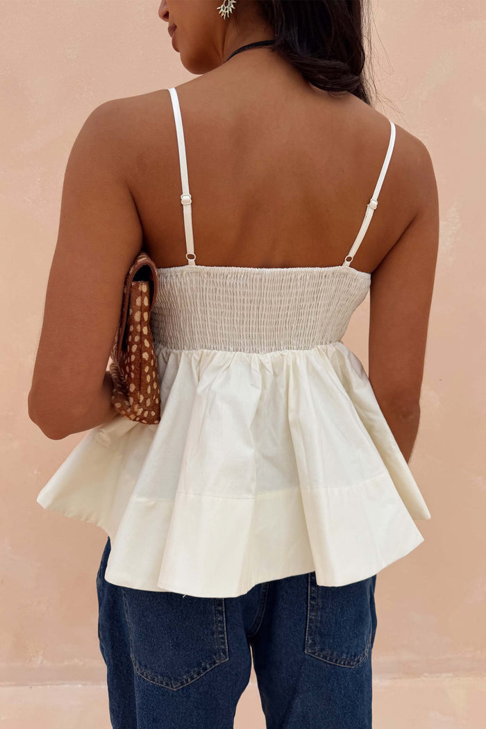 Ivory Palm Nara Top in cream cotton featuring a floaty peplum hem, shirred back and adjustable straps.