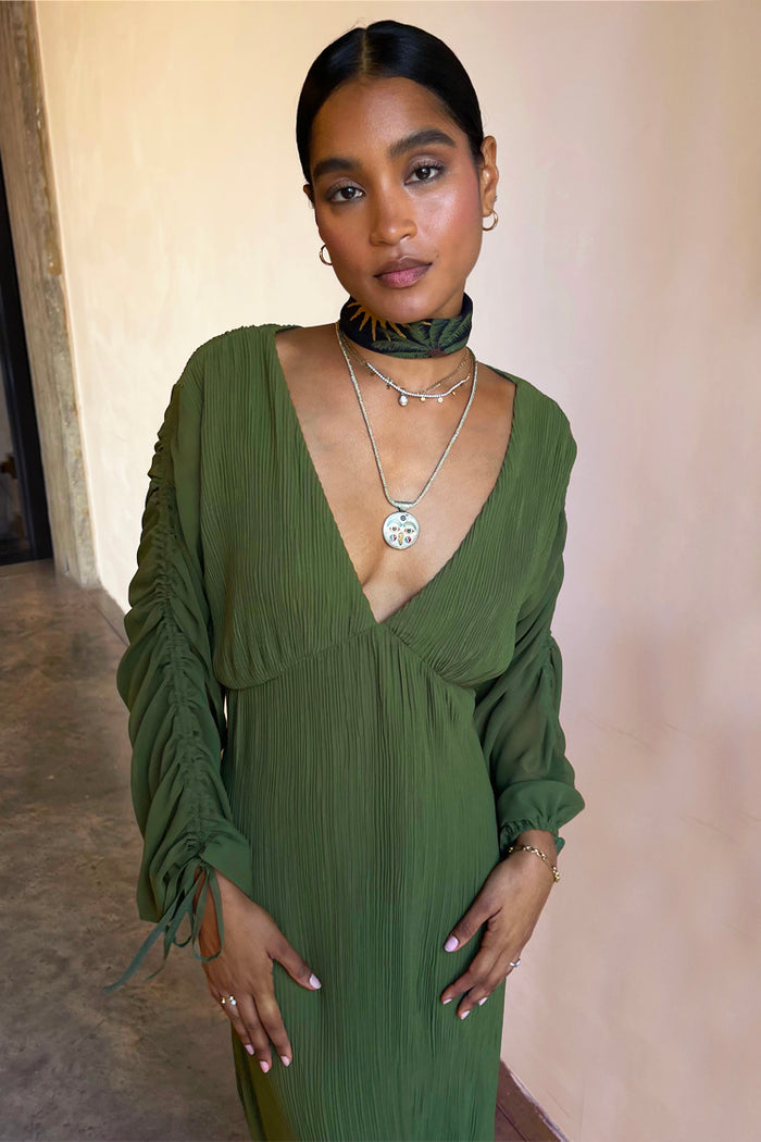 Khaki Celia Plisse Dress featuring a deep v-neck and sheer ruched sleeves with tie detailing.