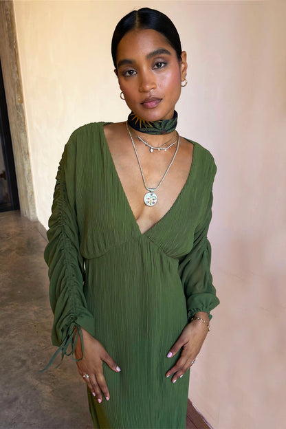 Khaki Celia Plisse Dress featuring a deep v-neck and sheer ruched sleeves with tie detailing.